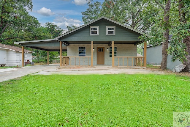 bungalow-style house featuring covered porch and a front lawn