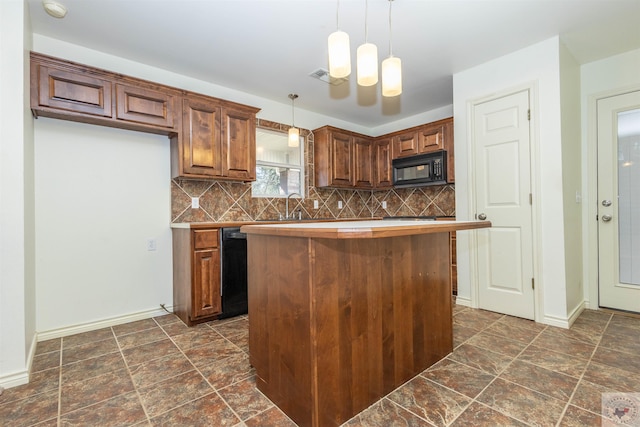 kitchen with hanging light fixtures, backsplash, black appliances, and a sink