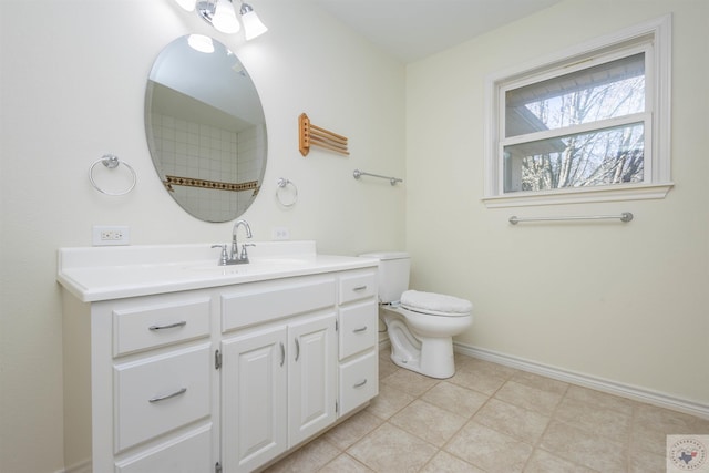 bathroom featuring tile patterned floors, toilet, vanity, and baseboards