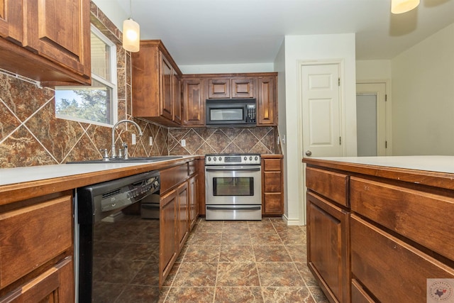 kitchen with decorative backsplash, black appliances, and a sink