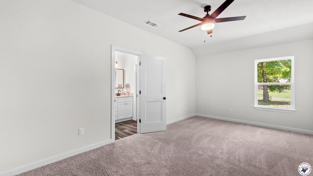 206 Spencer St, Maud, TX 75567 - unfurnished bedroom with carpet flooring, vaulted ceiling, connected bathroom, and ceiling fan