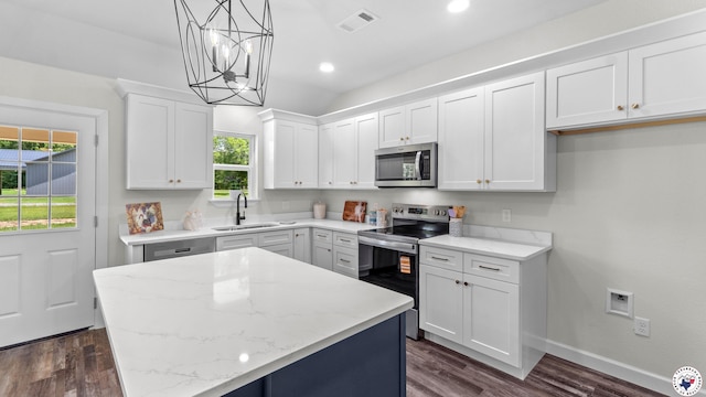 206 Spencer St, Maud, TX 75567 - kitchen with stainless steel appliances, a chandelier, white cabinetry, dark wood-style floors, and recessed lighting