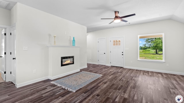206 Spencer St, Maud, TX 75567 - unfurnished living room featuring dark wood-type flooring, ceiling fan, a glass covered fireplace, and lofted ceiling