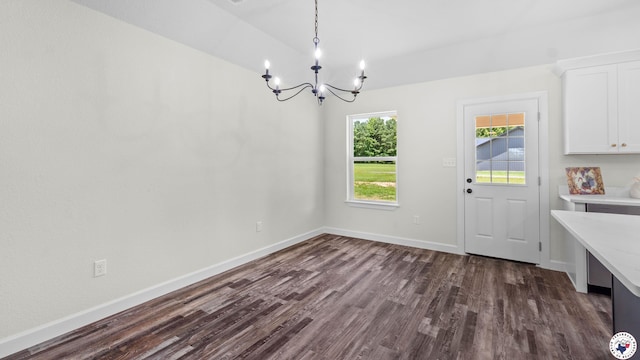 206 Spencer St, Maud, TX 75567 - unfurnished dining area with a chandelier and dark wood-style flooring
