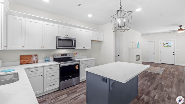 206 Spencer St, Maud, TX 75567 - kitchen with appliances with stainless steel finishes, white cabinetry, a center island, dark wood-style flooring, and recessed lighting