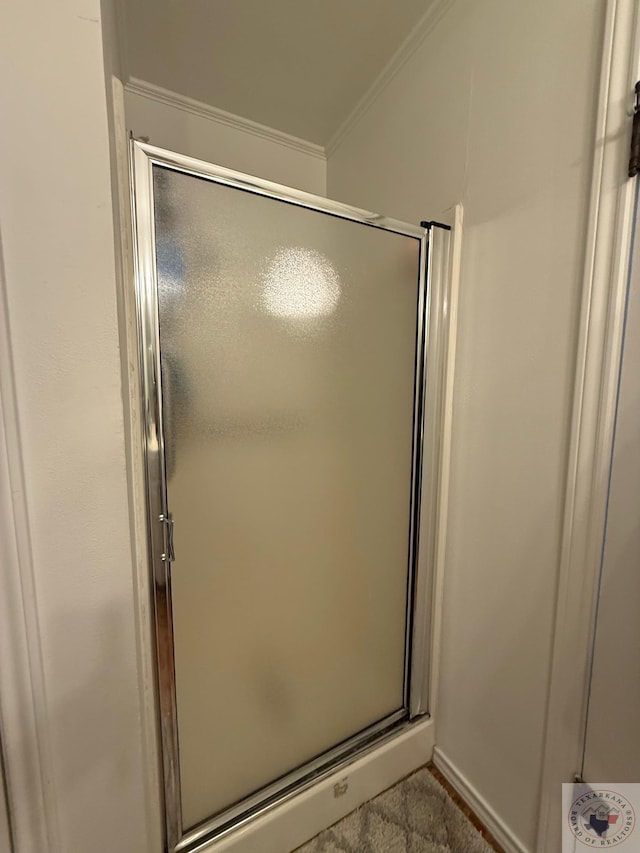 full bathroom featuring ornamental molding and a stall shower