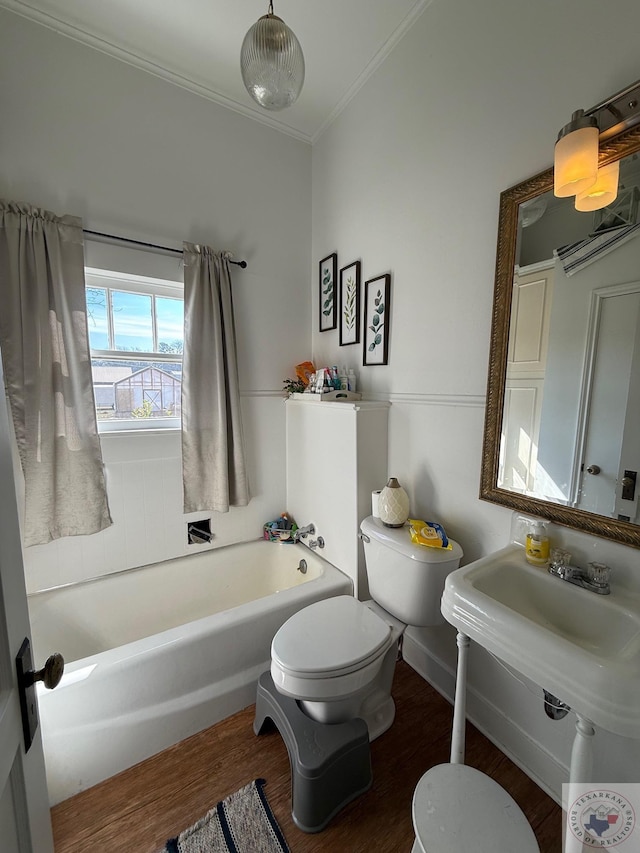 bathroom with ornamental molding, a tub to relax in, toilet, and wood finished floors