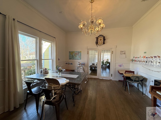 dining space featuring a notable chandelier, wood finished floors, and crown molding