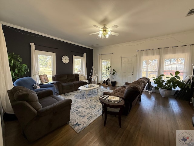 living room with ornamental molding, a wealth of natural light, and dark wood finished floors