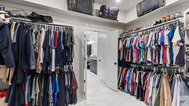 spacious closet with marble finish floor