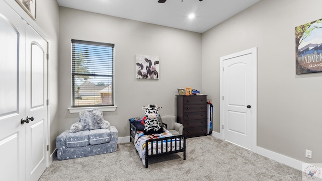 sitting room with carpet floors, a ceiling fan, and baseboards