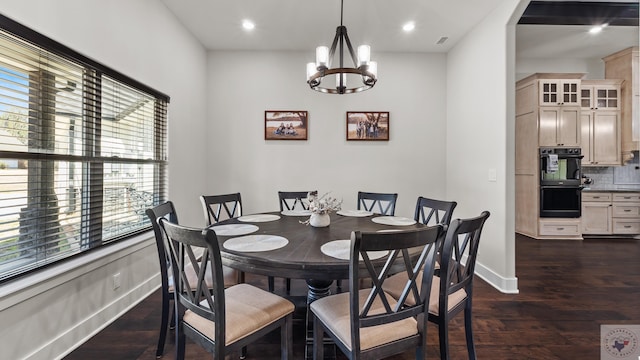 dining room with baseboards, dark wood finished floors, a notable chandelier, and recessed lighting