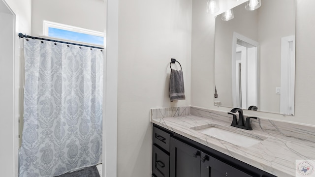 full bath with curtained shower and vanity