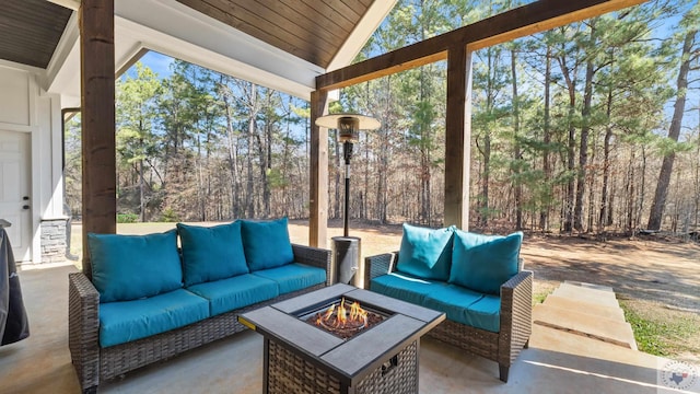 view of patio / terrace with an outdoor living space with a fire pit