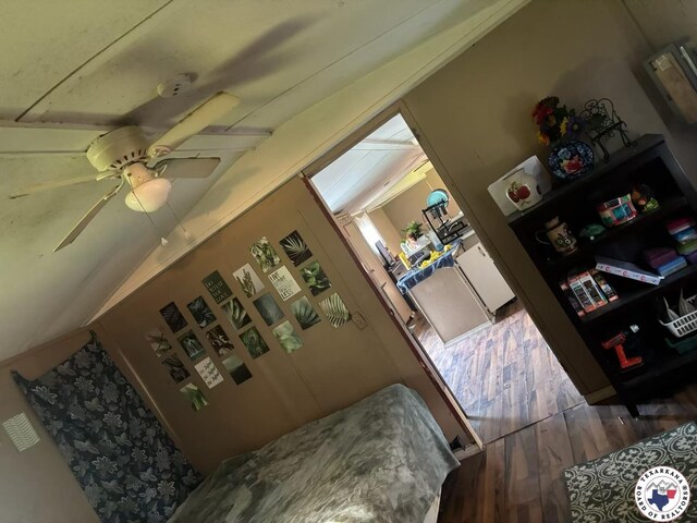 10720W.7TH Trexler Rd, Texarkana, TX 75501 - interior space with wood finished floors, a ceiling fan, and vaulted ceiling