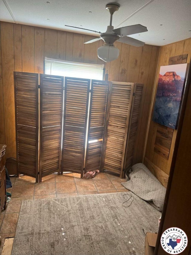 10720W.7TH Trexler Rd, Texarkana, TX 75501 - unfurnished bedroom featuring wooden walls and a textured ceiling