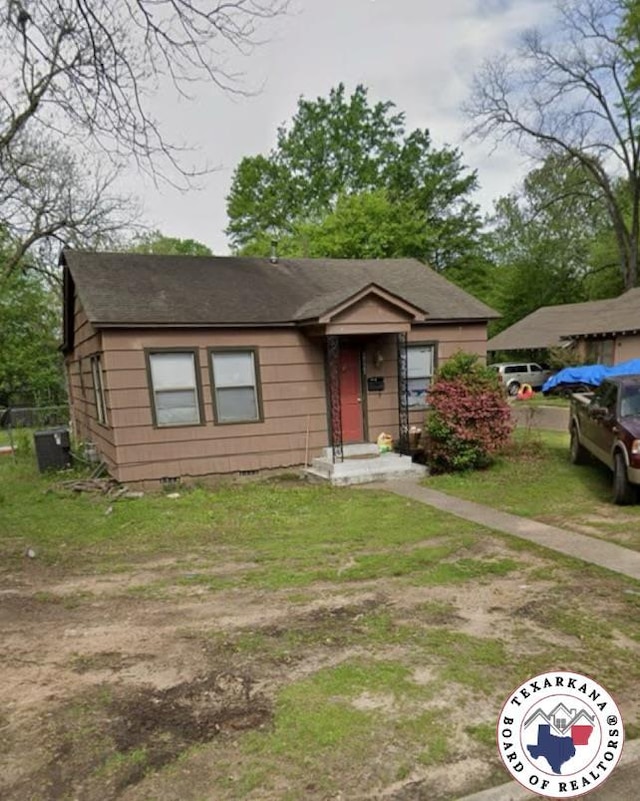 2523 Pine, Texarkana, TX 75503 - view of front of house featuring crawl space, central air condition unit, and a shingled roof