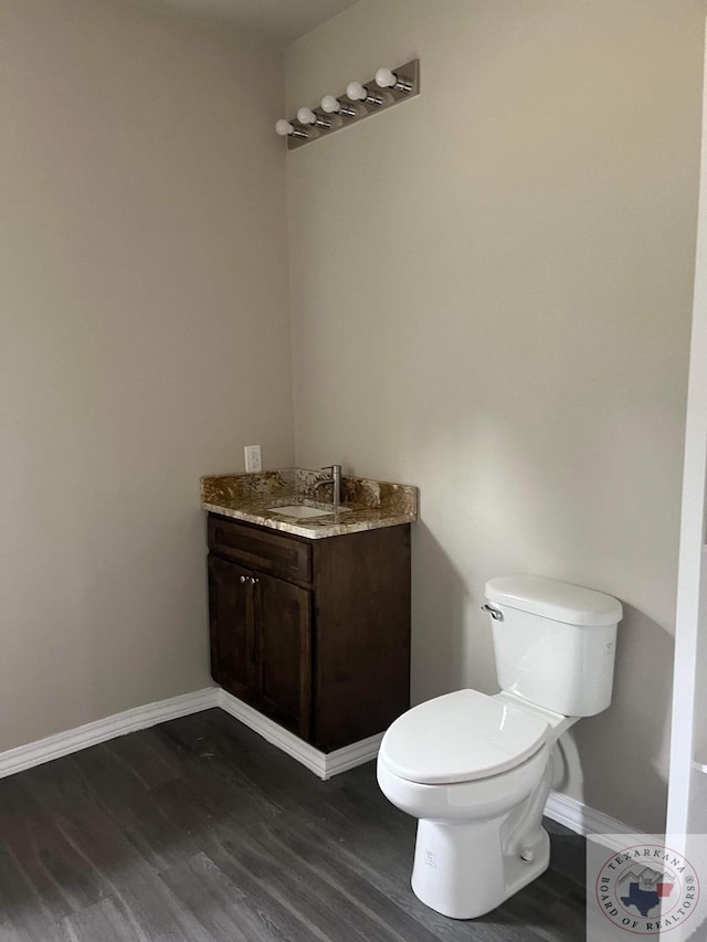 bathroom featuring vanity, toilet, and wood-type flooring