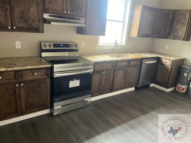 kitchen with dark brown cabinetry and appliances with stainless steel finishes