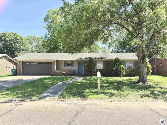 4211 Lotus Dr, Texarkana, TX 75503 - single story home featuring driveway, a garage, a front lawn, and brick siding
