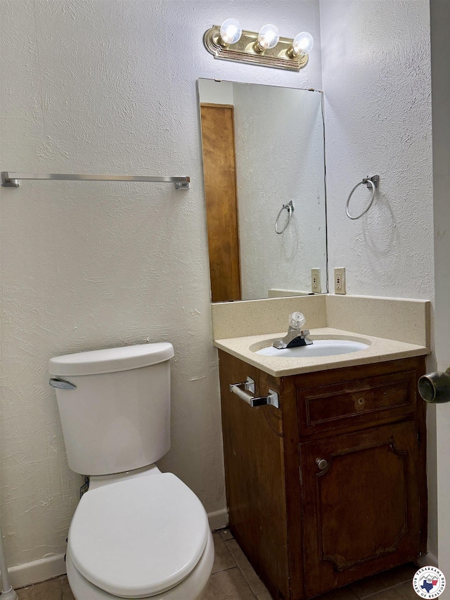 4211 Lotus Dr, Texarkana, TX 75503 - bathroom with toilet, vanity, and tile patterned floors