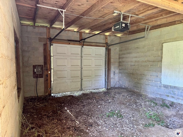 4211 Lotus Dr, Texarkana, TX 75503 - garage featuring a garage door opener and concrete block wall