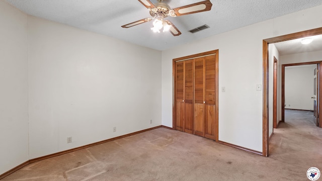 1135 Cook Rd, Texarkana, AR 71854 - unfurnished bedroom featuring light colored carpet, a closet, a textured ceiling, and ceiling fan
