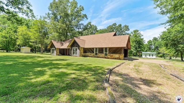 1135 Cook Rd, Texarkana, AR 71854 - chalet / cabin featuring stone siding, a front yard, a shed, and driveway
