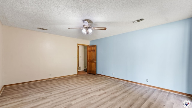 1135 Cook Rd, Texarkana, AR 71854 - unfurnished room featuring light wood finished floors, ceiling fan, and a textured ceiling