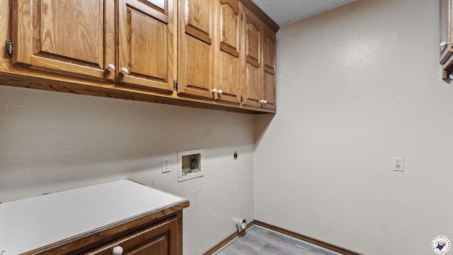 1135 Cook Rd, Texarkana, AR 71854 - washroom with cabinet space, hookup for a washing machine, light wood-style floors, and electric dryer hookup