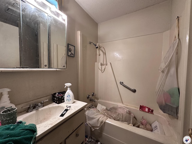 216 W Pioneer St, Wake Village, TX 75501 - bathroom with bathing tub / shower combination, vanity, and a textured ceiling
