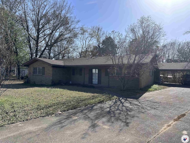 216 W Pioneer St, Wake Village, TX 75501 - single story home featuring a carport, a front yard, and concrete driveway