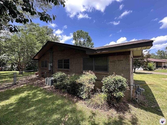 216 W Pioneer St, Wake Village, TX 75501 - view of side of property featuring a central air condition unit and brick siding