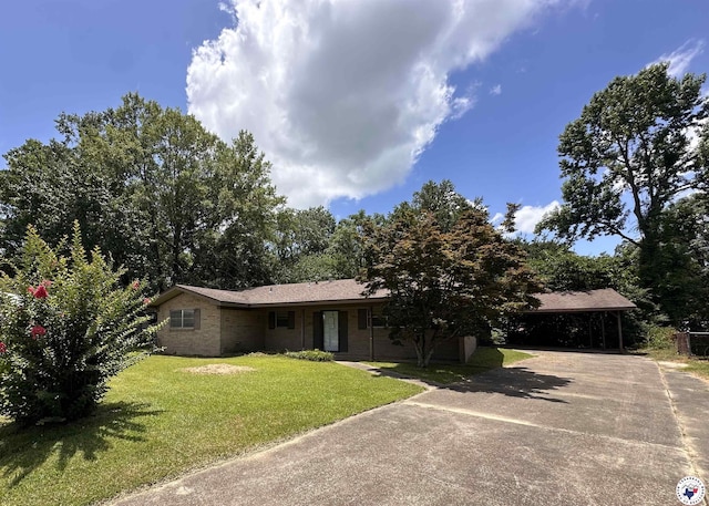 216 W Pioneer St, Wake Village, TX 75501 - ranch-style house featuring a carport, concrete driveway, and a front yard
