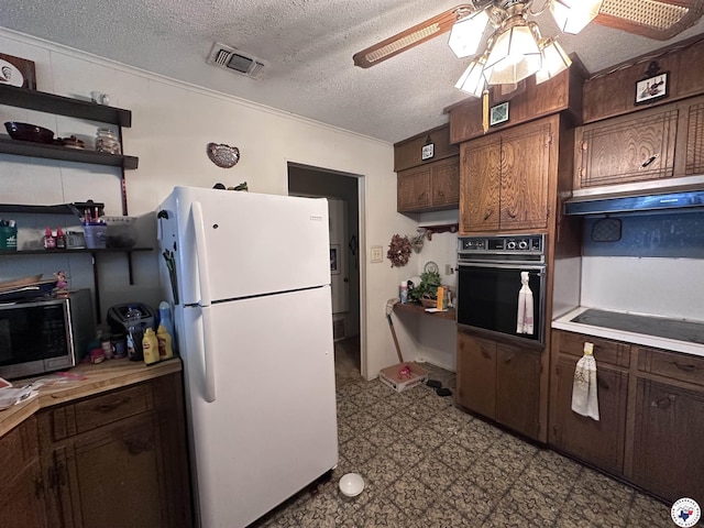 216 W Pioneer St, Wake Village, TX 75501 - kitchen with freestanding refrigerator, oven, ceiling fan, stainless steel microwave, and light countertops