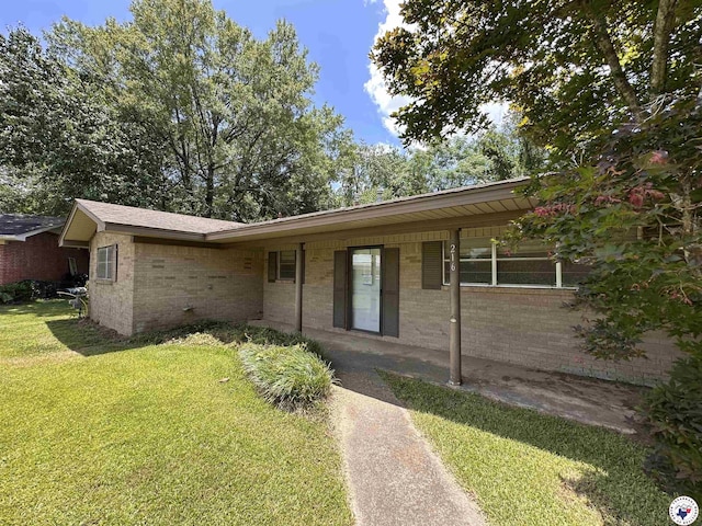 216 W Pioneer St, Wake Village, TX 75501 - ranch-style house with a front lawn and brick siding