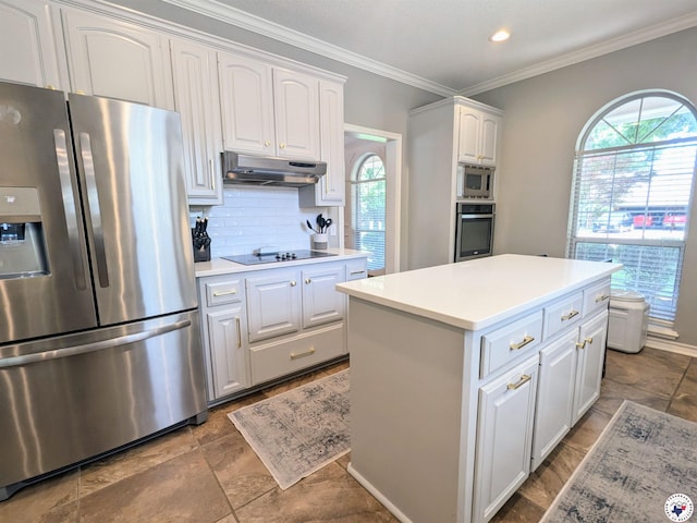 3815 Wyatt Ln, Texarkana, TX 75503 - kitchen with stainless steel appliances, under cabinet range hood, plenty of natural light, white cabinetry, and ornamental molding