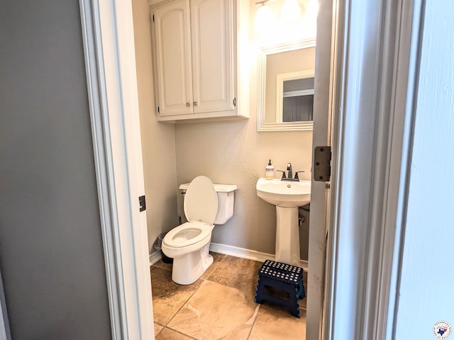 3815 Wyatt Ln, Texarkana, TX 75503 - bathroom with toilet, tile patterned flooring, a sink, and baseboards