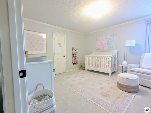 3815 Wyatt Ln, Texarkana, TX 75503 - bedroom with carpet, a textured ceiling, ornamental molding, a nursery area, and baseboards