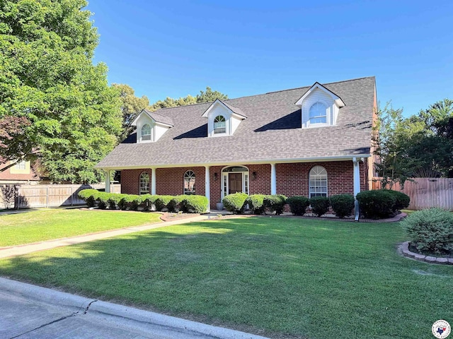 3815 Wyatt Ln, Texarkana, TX 75503 - cape cod-style house with brick siding, roof with shingles, and a porch