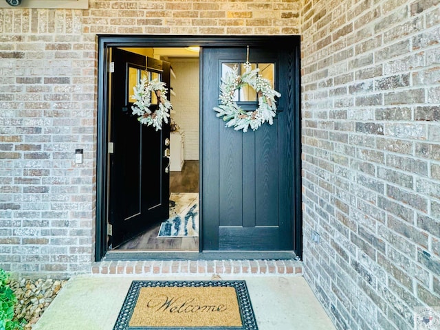 property entrance with brick siding