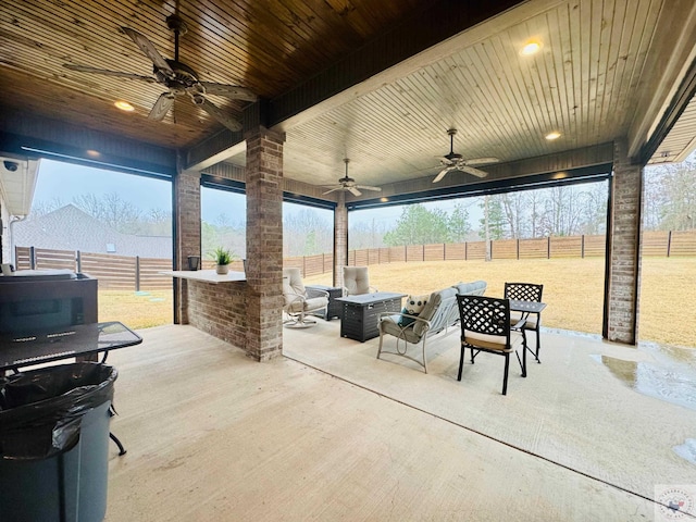 view of patio with a fenced backyard and a ceiling fan