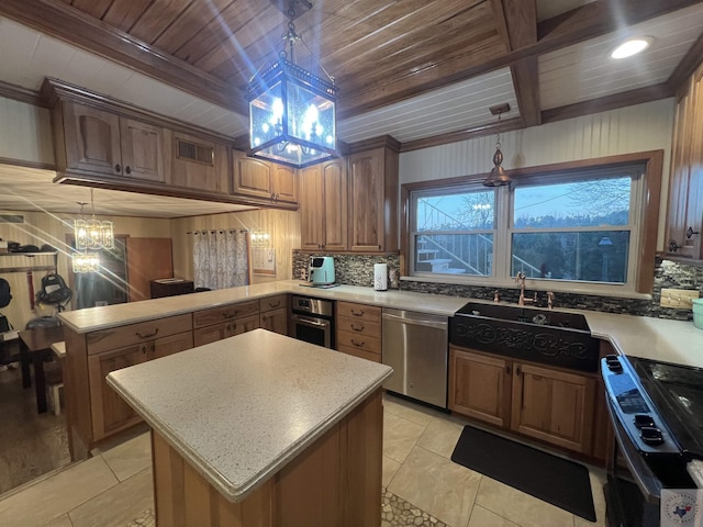 kitchen with sink, a chandelier, a center island, hanging light fixtures, and stainless steel appliances