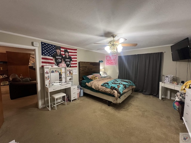 carpeted bedroom with ornamental molding, ceiling fan, and a textured ceiling