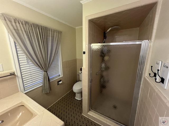 bathroom featuring toilet, an enclosed shower, tile walls, ornamental molding, and vanity