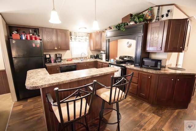 kitchen featuring dark wood finished floors, lofted ceiling, a sink, black appliances, and light countertops