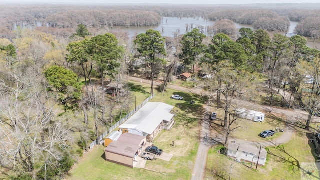 bird's eye view featuring a wooded view and a water view