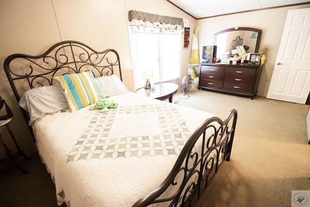 carpeted bedroom featuring crown molding and vaulted ceiling