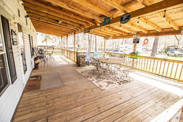 wooden terrace featuring outdoor dining area