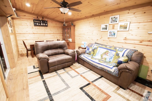 living room with wood walls, wood ceiling, ceiling fan, and wood finished floors